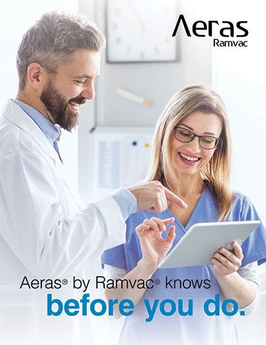 Two dentists looking at a tablet on the Aeras brochure cover
